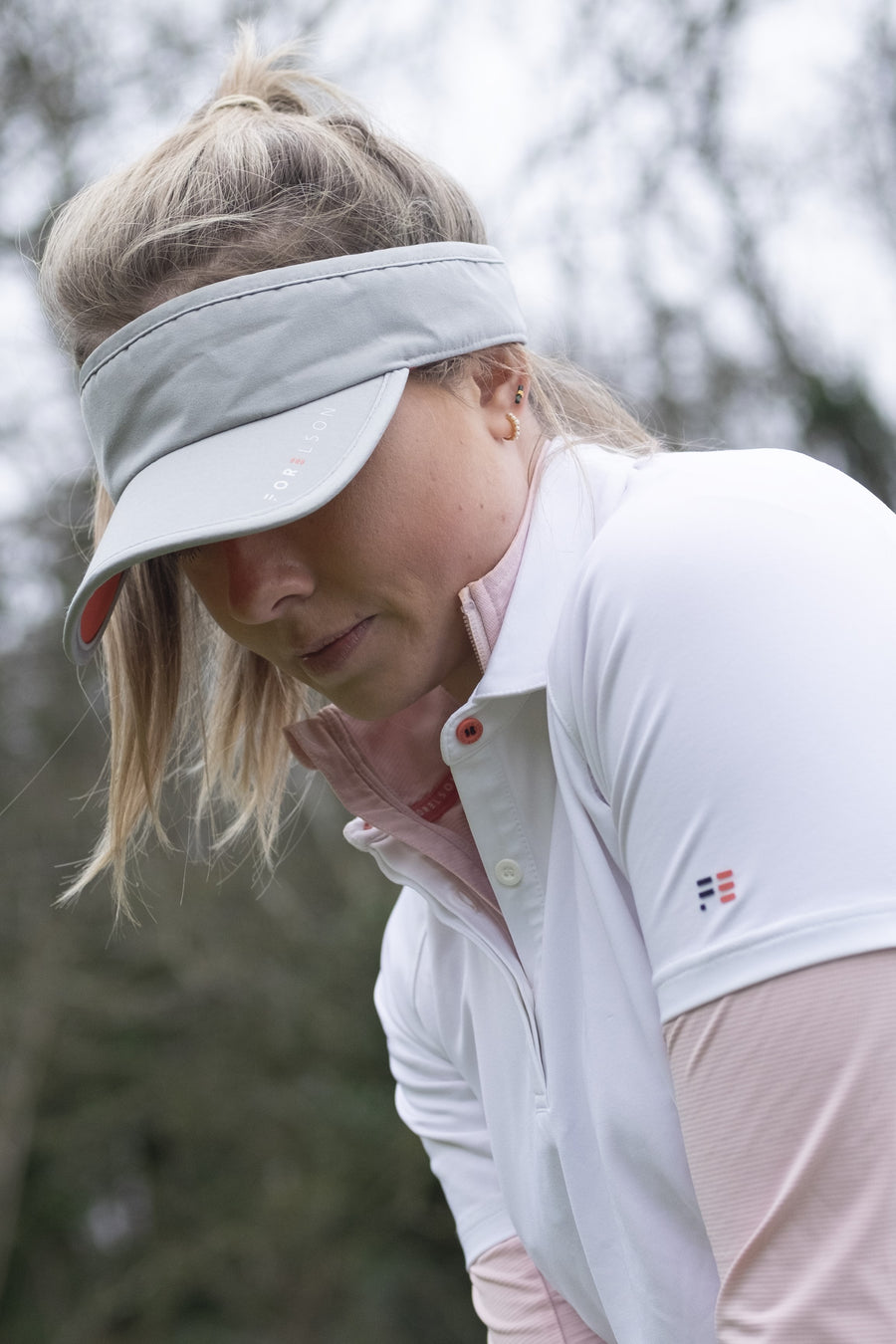 Women's white golf polo shirt. Lightweight breathable fabric.