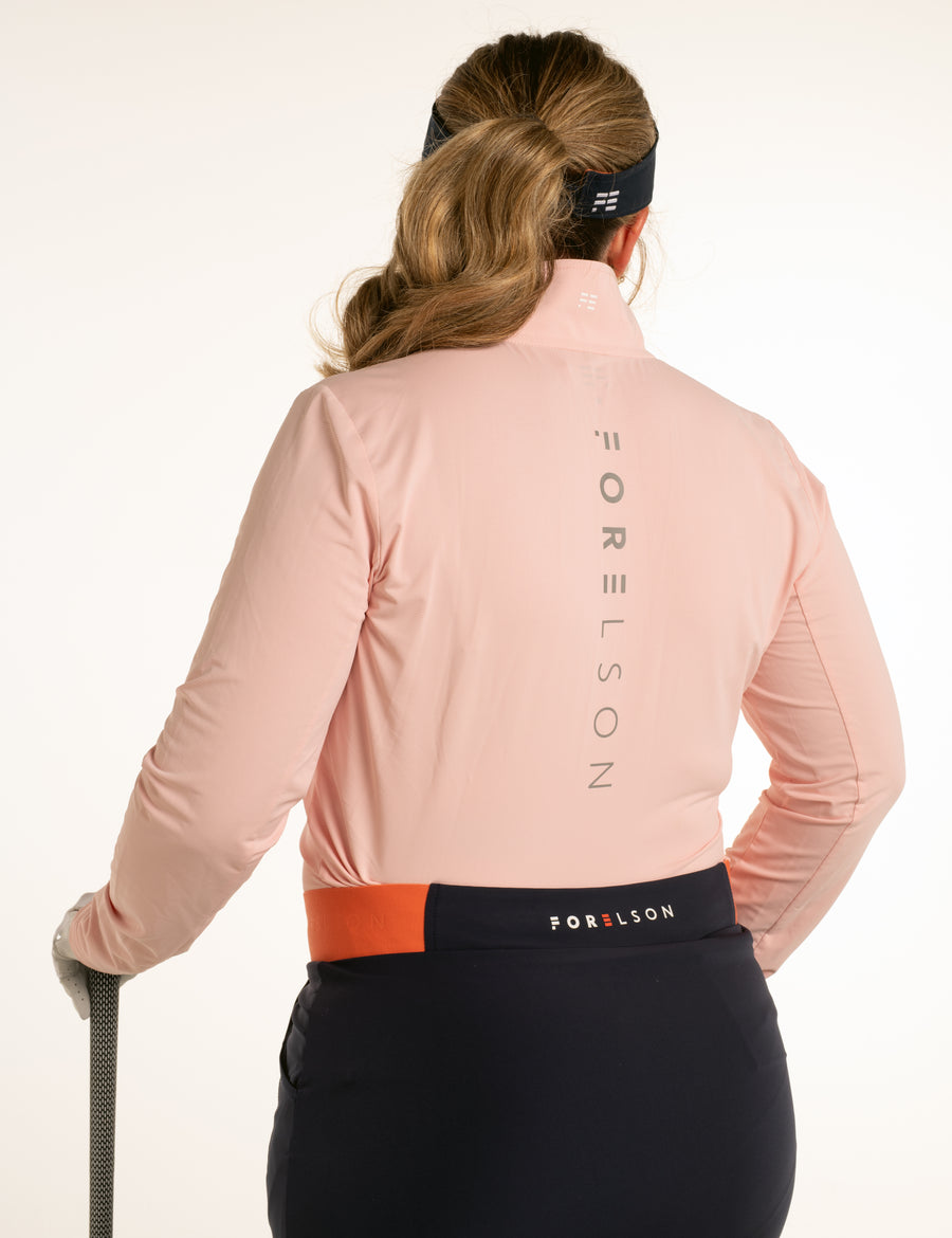 Women's pink golf under-layer. Long sleeved, zip up, polo collar. Lightweight, wicking qualities.
