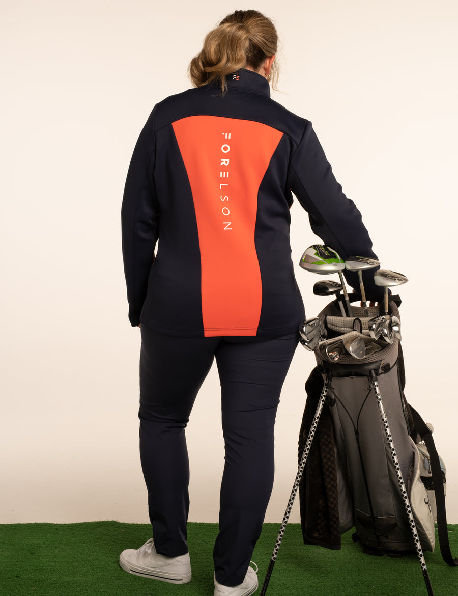 Women's navy and orange zip up golf jacket. Soft fabric that will stretch, allowing movement.