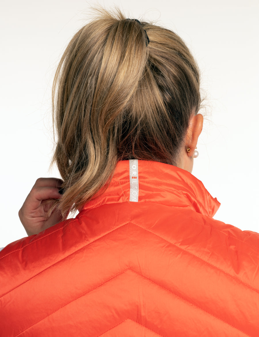 Women's orange golf gilet. Lightweight material, zip up with pockets. 