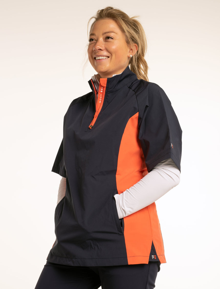 Women's navy and orange, short sleeved golf jacket. Water resistant windbreaker, lightweight material.