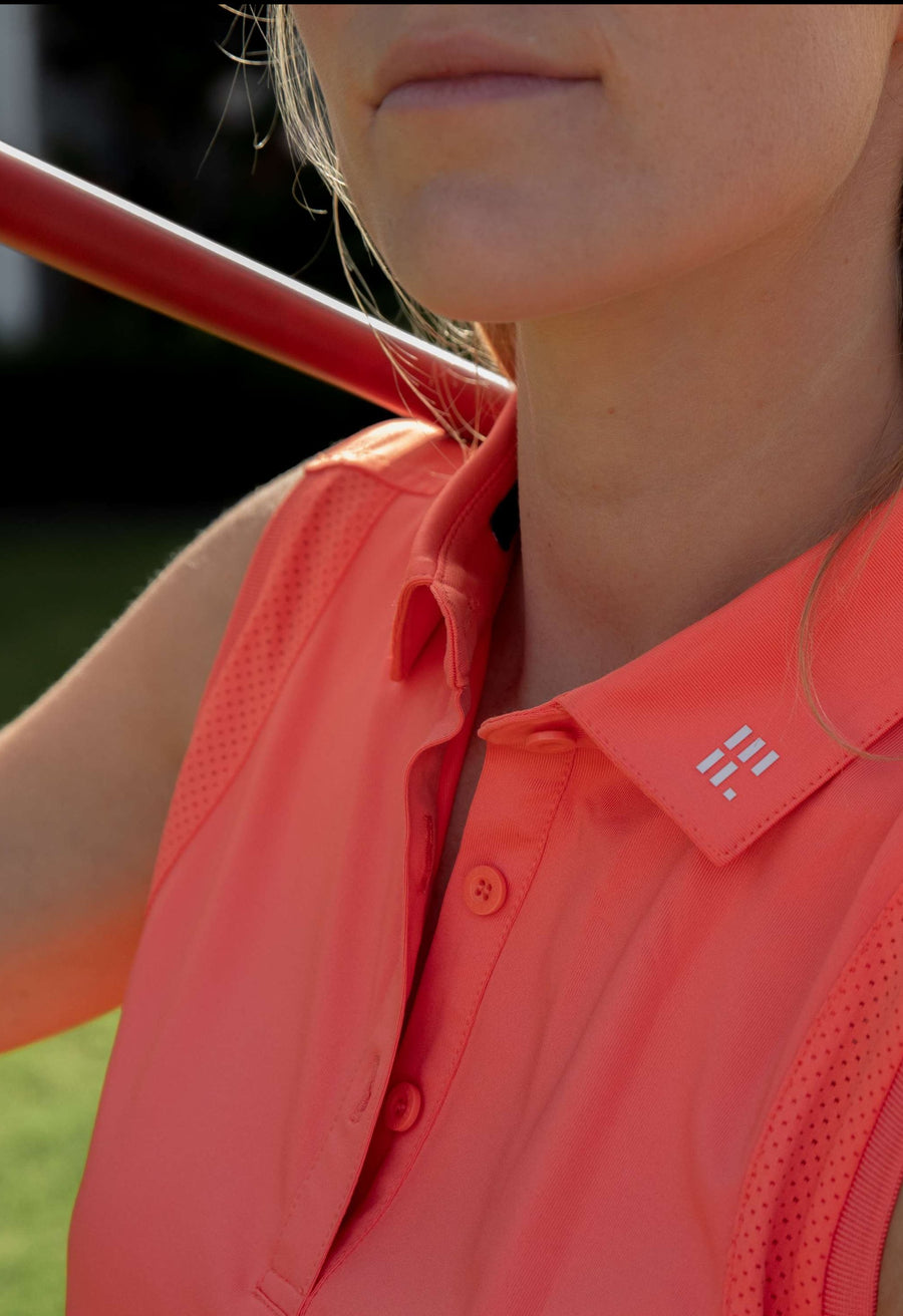 Women's orange sleeveless golf polo. Wicking fabric and UPF50 sun protection.