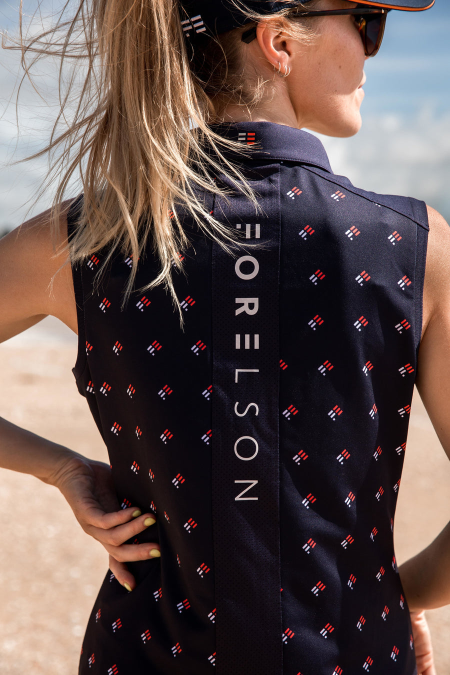 Women's navy sleeveless golf polo. Lightweight, wicking fabric. UPF50 sun protection.
