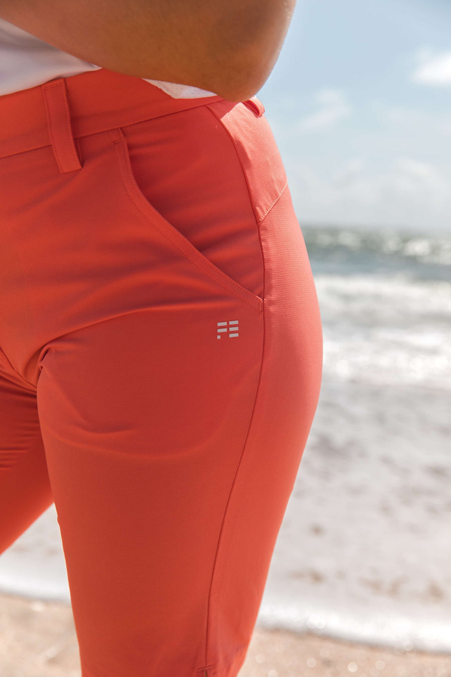 Women's orange golf shorts. Lightweight, technical fabric. 